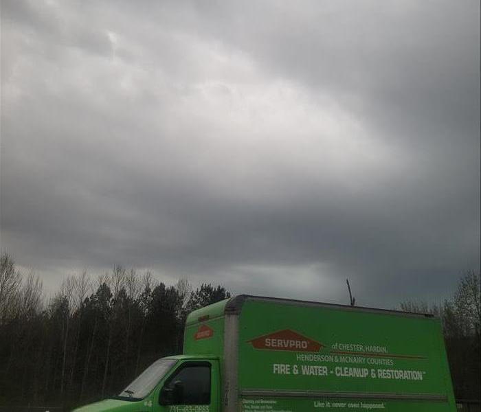Gray storm clouds with SERVPRO truck